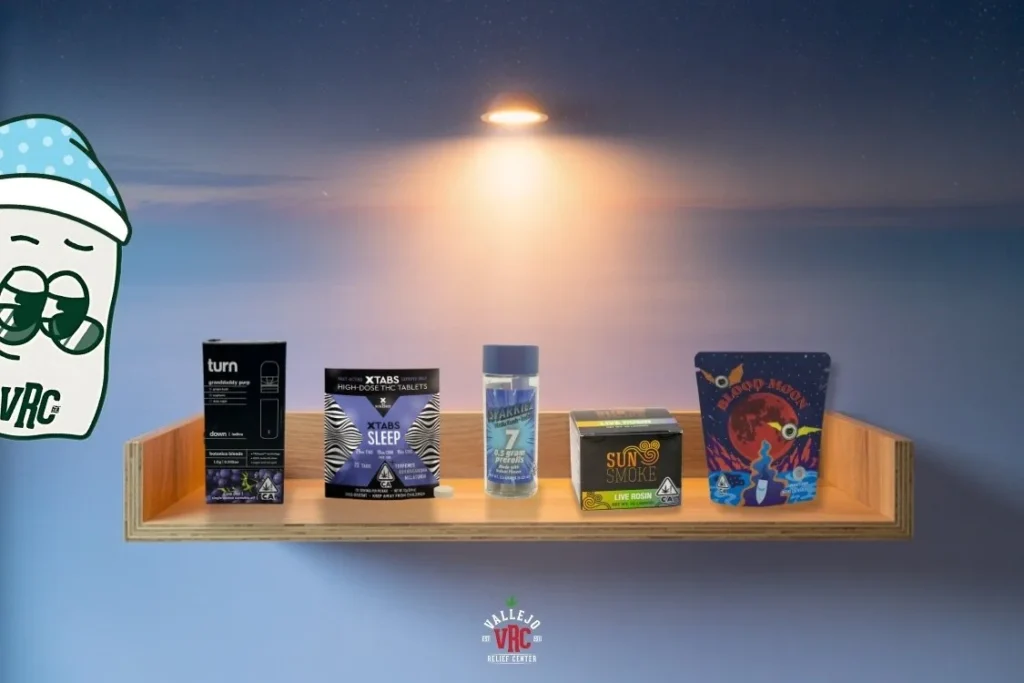 Five cannabis sleep products displayed on a floating wooden shelf under soft, warm light against a twilight sky background. Packaging includes Granddaddy Purp vape, XTABS Sleep tablets, Sparkiez pre-rolls, Sun Smoke live rosin, and Blood Moon flower. A sleepy cartoon character and Vallejo Relief Center logo are also visible.