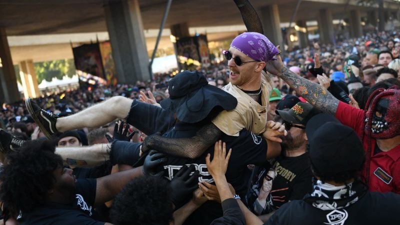 Fans lifting a crowd-surfer during a high-energy rock set at the Aftershock Festival in Sacramento.