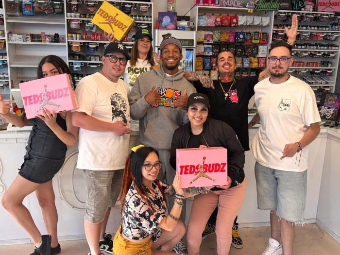Teds Budz team posing with Vallejo Relief Center staff during an in-store brand demo, holding Teds Budz signage inside the dispensary.