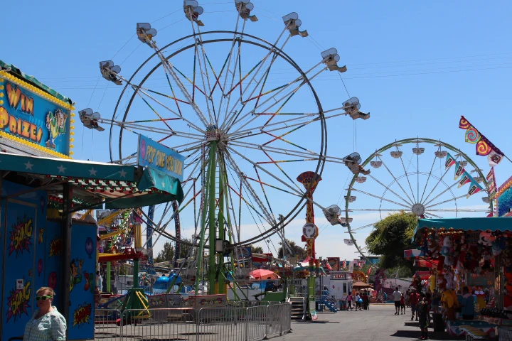 Colorful carnival rides and Ferris wheel at the Solano County Fair in Vallejo, California.