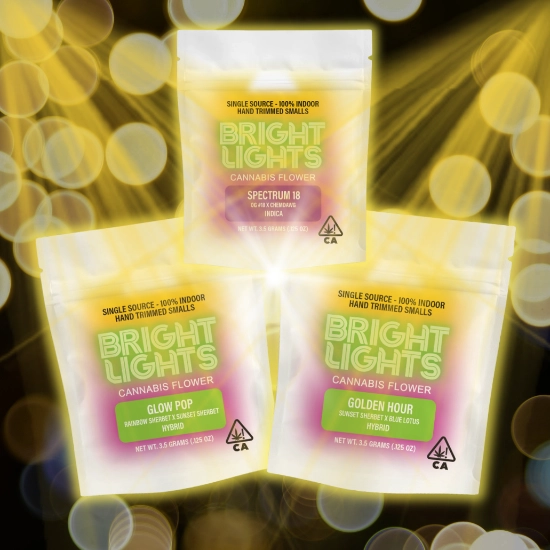 Three Bright Lights cannabis flower bags displayed against a glowing gold background, featuring Spectrum 18 (Indica), Glow Pop (Hybrid), and Golden Hour (Hybrid), labeled as single-source, 100% indoor, hand-trimmed smalls.