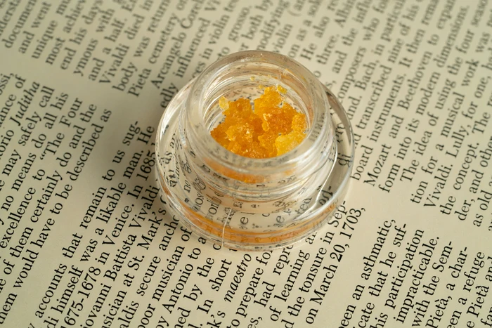 golden cannabis concentrate in a glass jar for 710 Dab Day