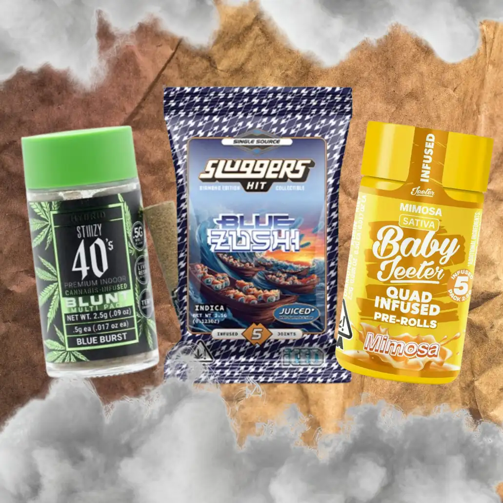 vrc-prerolls-landing-page-product-highlight Three pre-roll products on a smoky brown paper background: STIIIZY 40s Blue Burst infused blunt, Sluggers Blue Zushi 5-pack, and Baby Jeeter Mimosa quad-infused pre-rolls, all sold at Vallejo Relief Center.